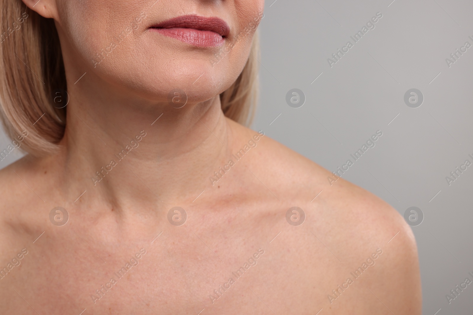 Photo of Woman with healthy skin on grey background, closeup