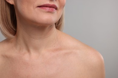 Photo of Woman with healthy skin on grey background, closeup