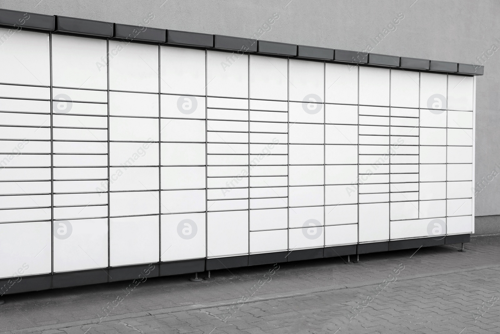 Photo of Modern parcel locker with many postal boxes outdoors