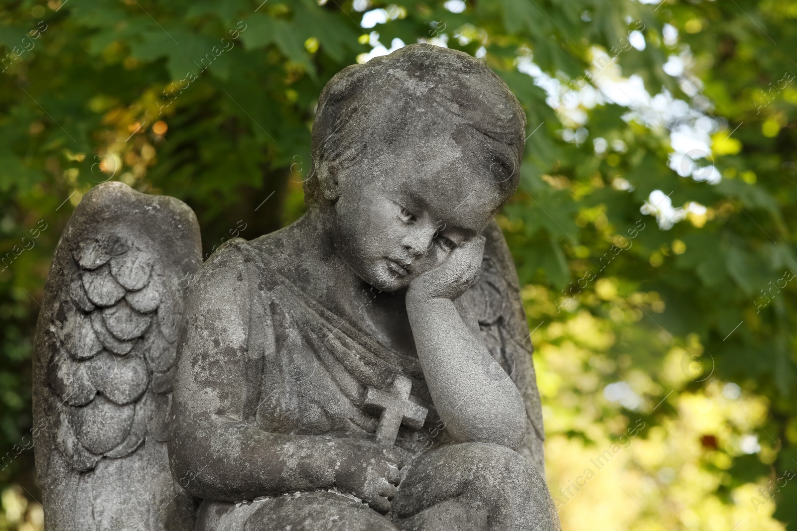 Photo of Beautiful statue of angel at cemetery on sunny day, space for text. Funeral ceremony