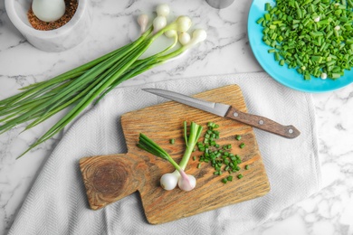 Photo of Beautiful composition with fresh green onion on table, top view