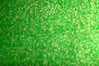 Image of St. Patrick day. Green glitter as background, blurred view. Bokeh effect