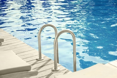 Photo of Modern swimming pool with step ladder outdoor