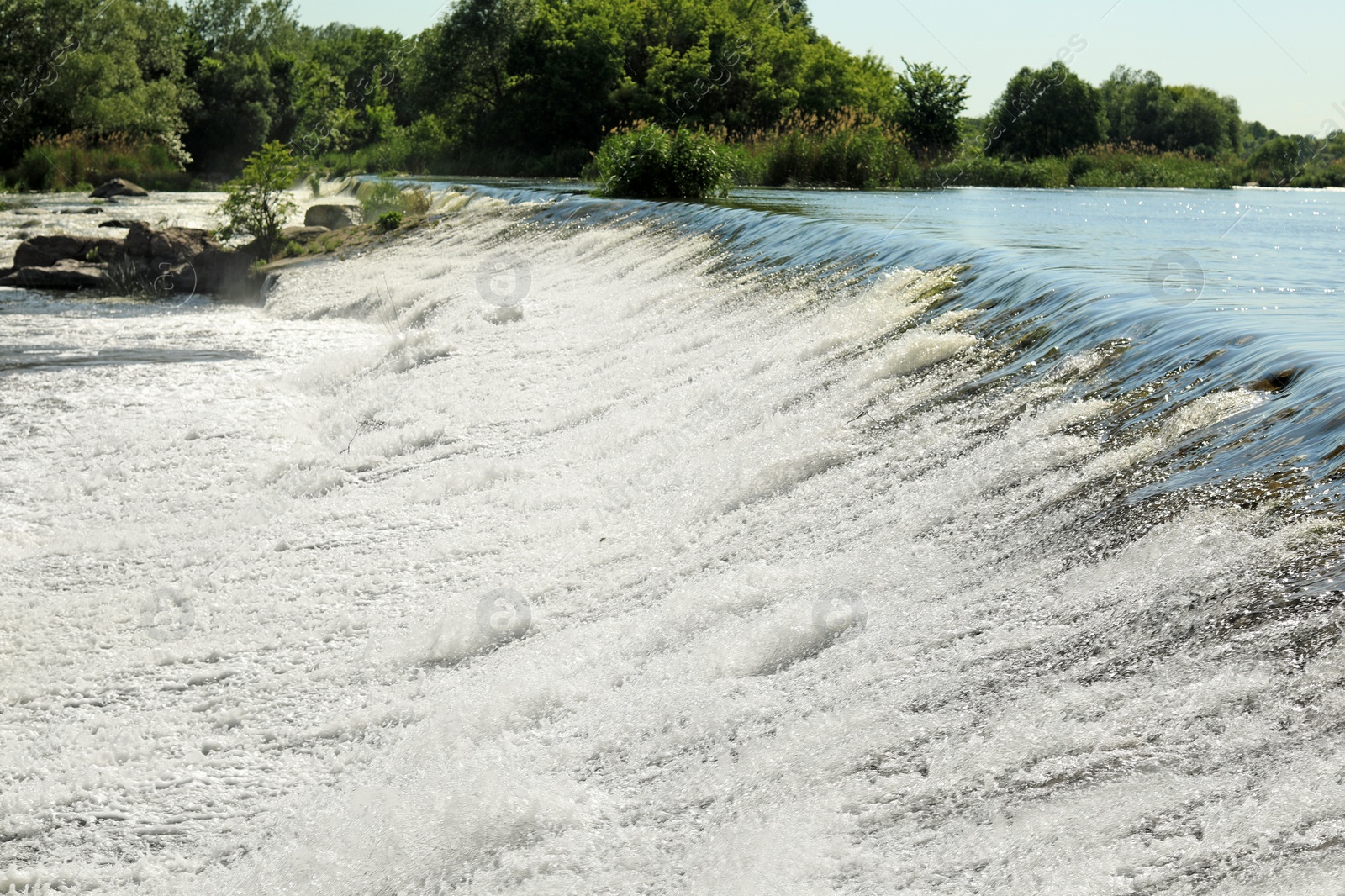 Photo of Fast river with rapids on sunny day