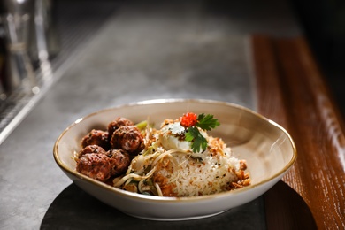 Photo of Plate with rice and meat balls served on table