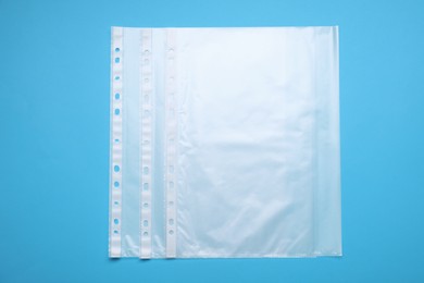 Punched pockets on light blue background, flat lay