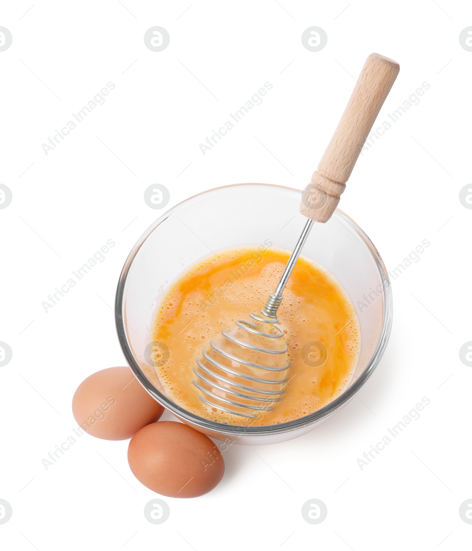 Photo of Beaten eggs and whisk in glass bowl isolated on white