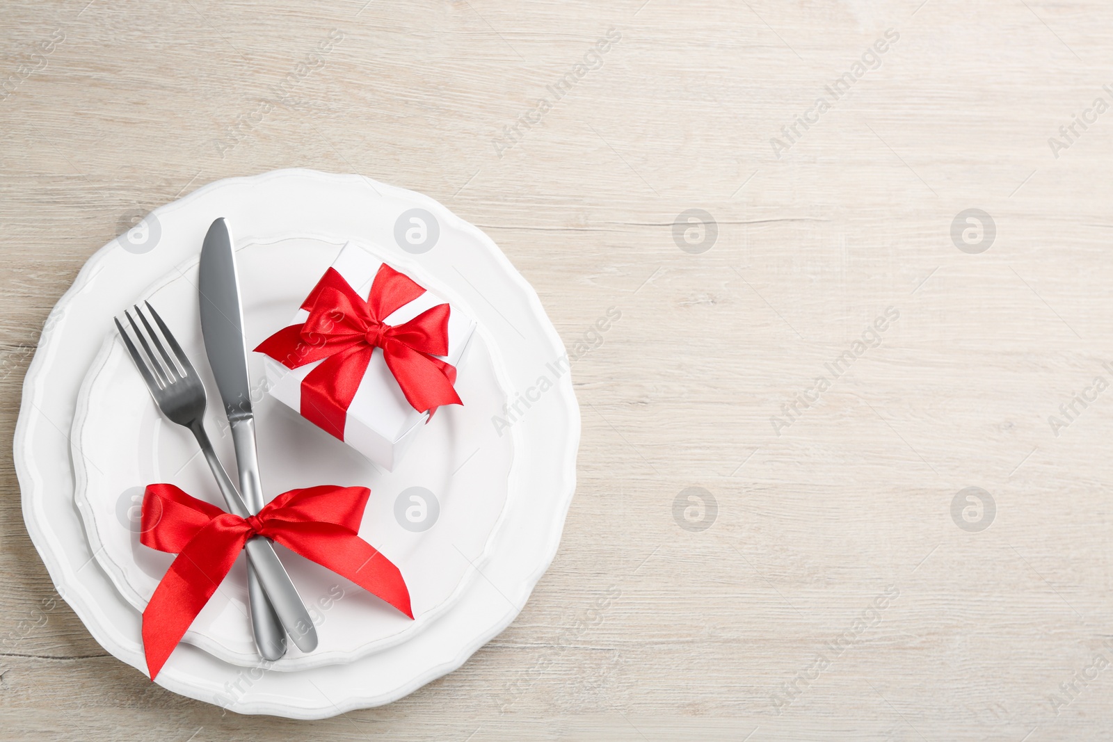 Photo of Beautiful table setting on white wooden background, top view with space for text. Valentine's Day dinner