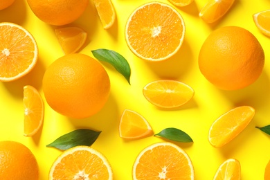 Flat lay composition with ripe oranges on color background