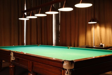 Photo of Empty green billiard table in club. Pool Game