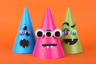 Photo of Spooky paper Halloween monsters on orange background