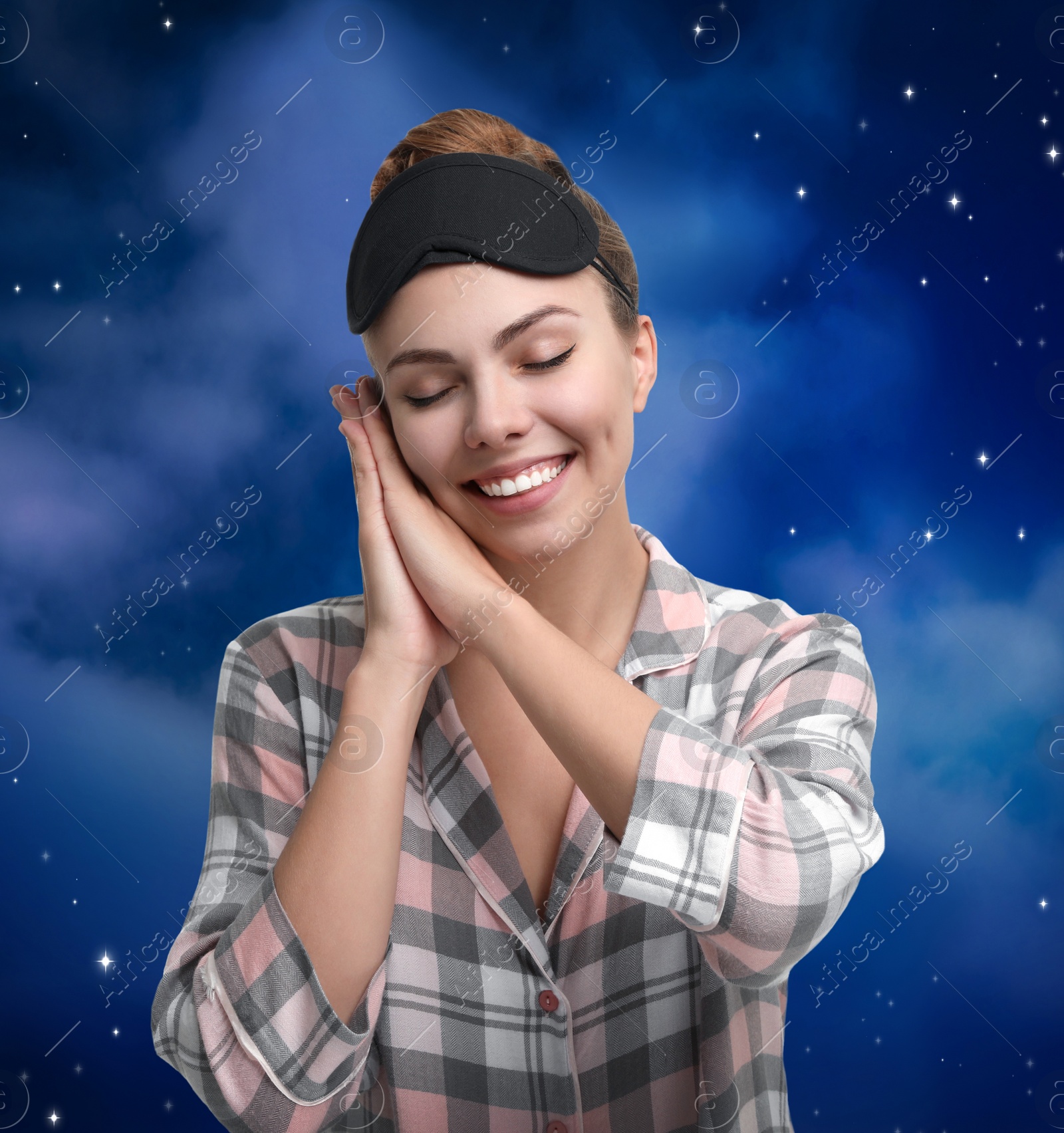 Image of Beautiful woman and night starry sky on background. Bedtime