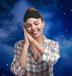 Image of Beautiful woman and night starry sky on background. Bedtime