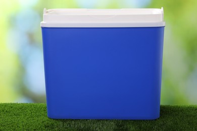 One plastic cool box on artificial grass, closeup