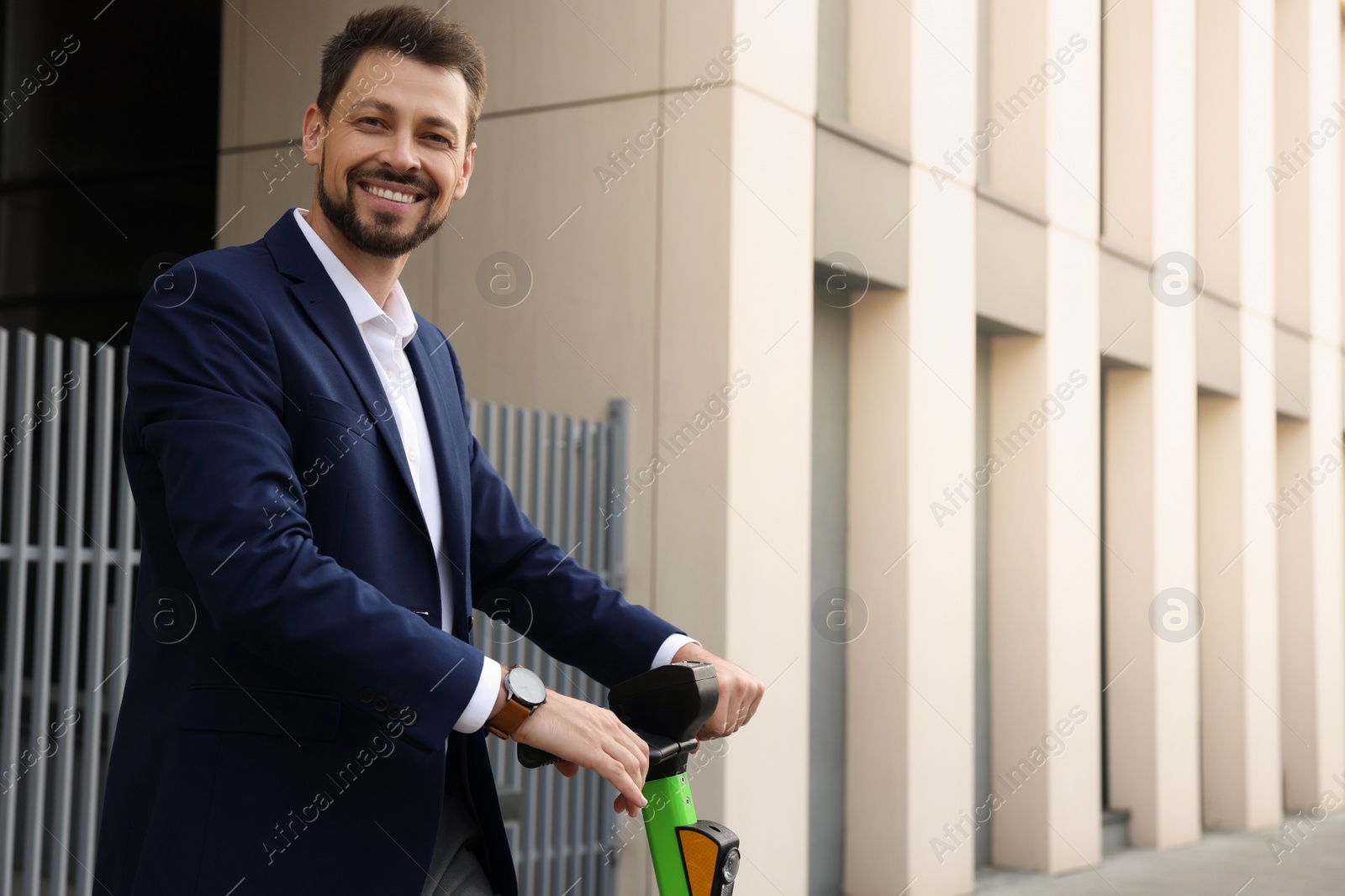 Photo of Businessman with modern kick scooter on city street, space for text