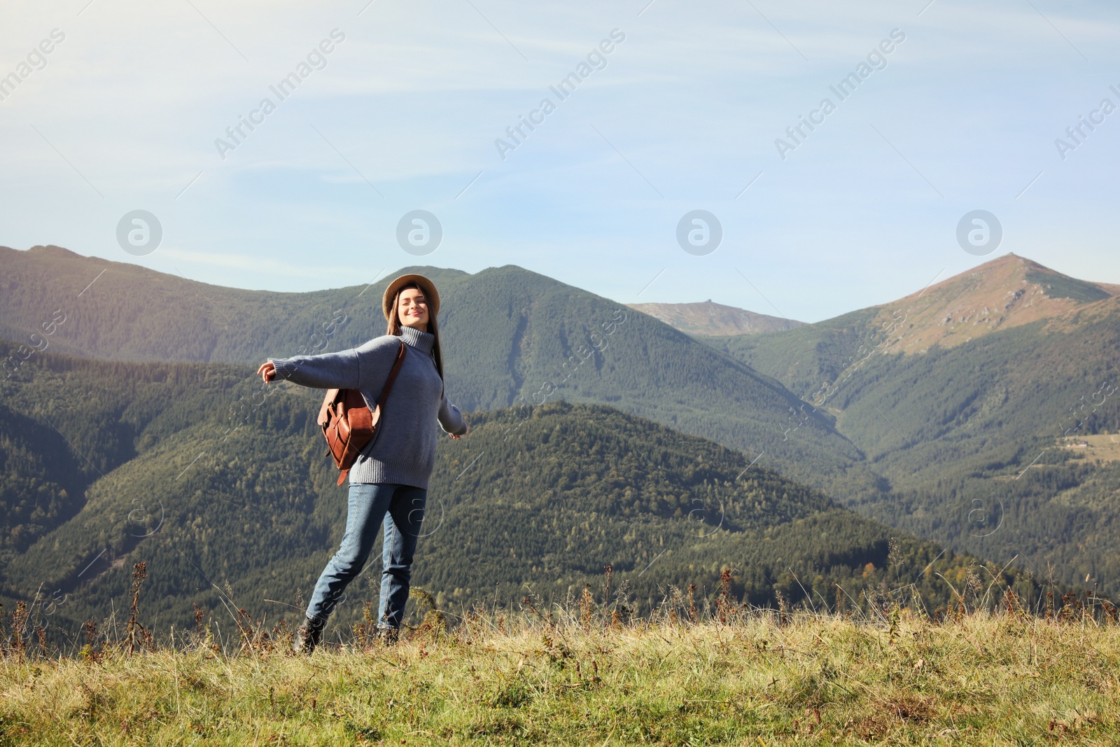 Photo of Young woman in beautiful mountains on sunny day