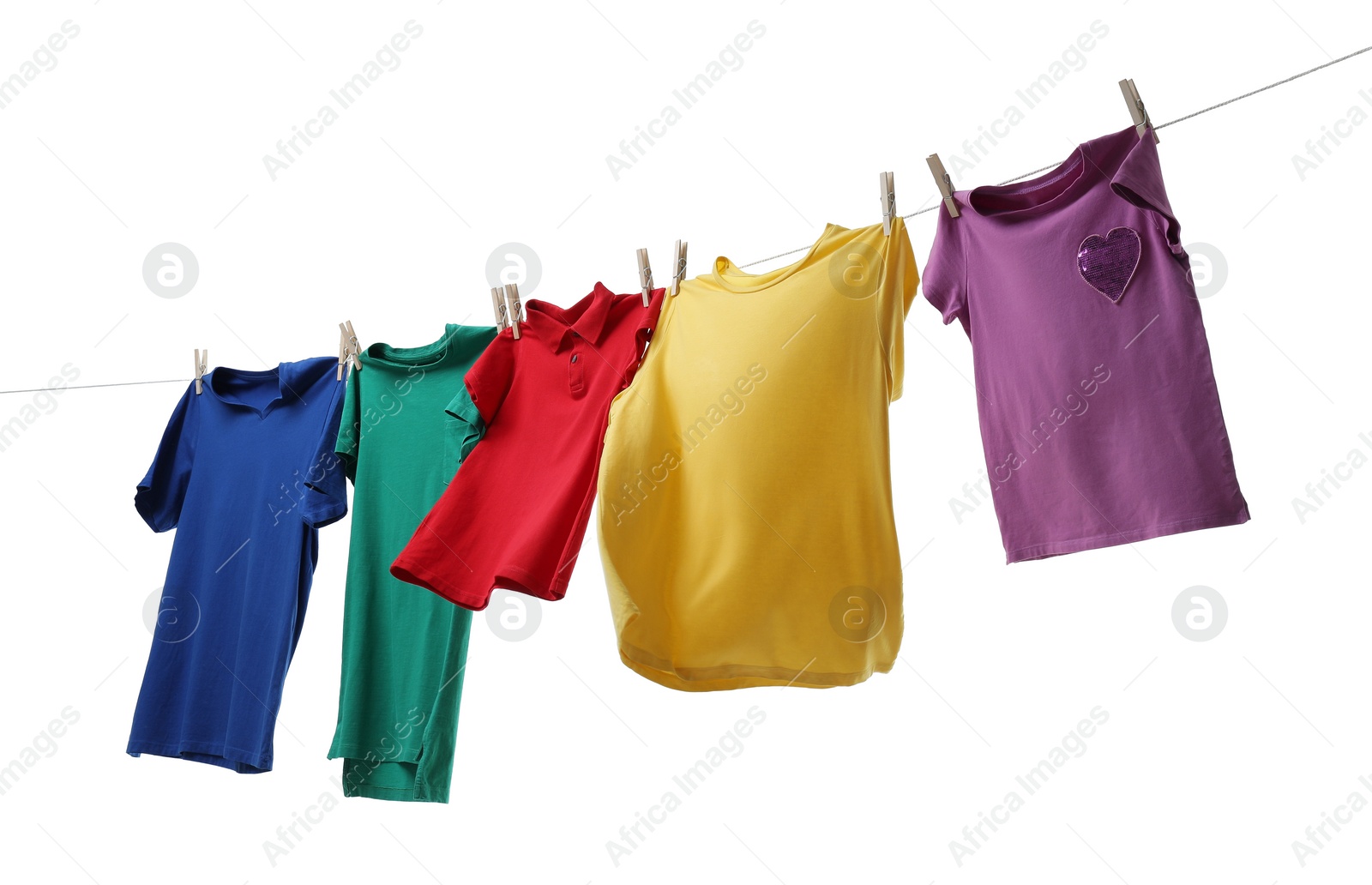 Photo of Colorful t-shirts drying on washing line isolated on white