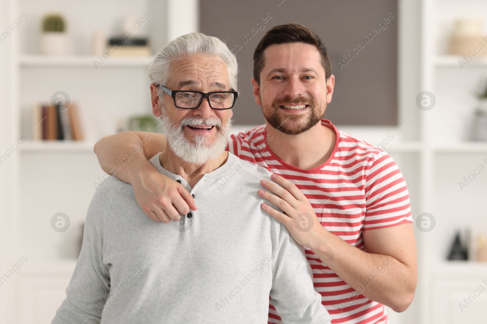 Photo of Happy son and his dad at home