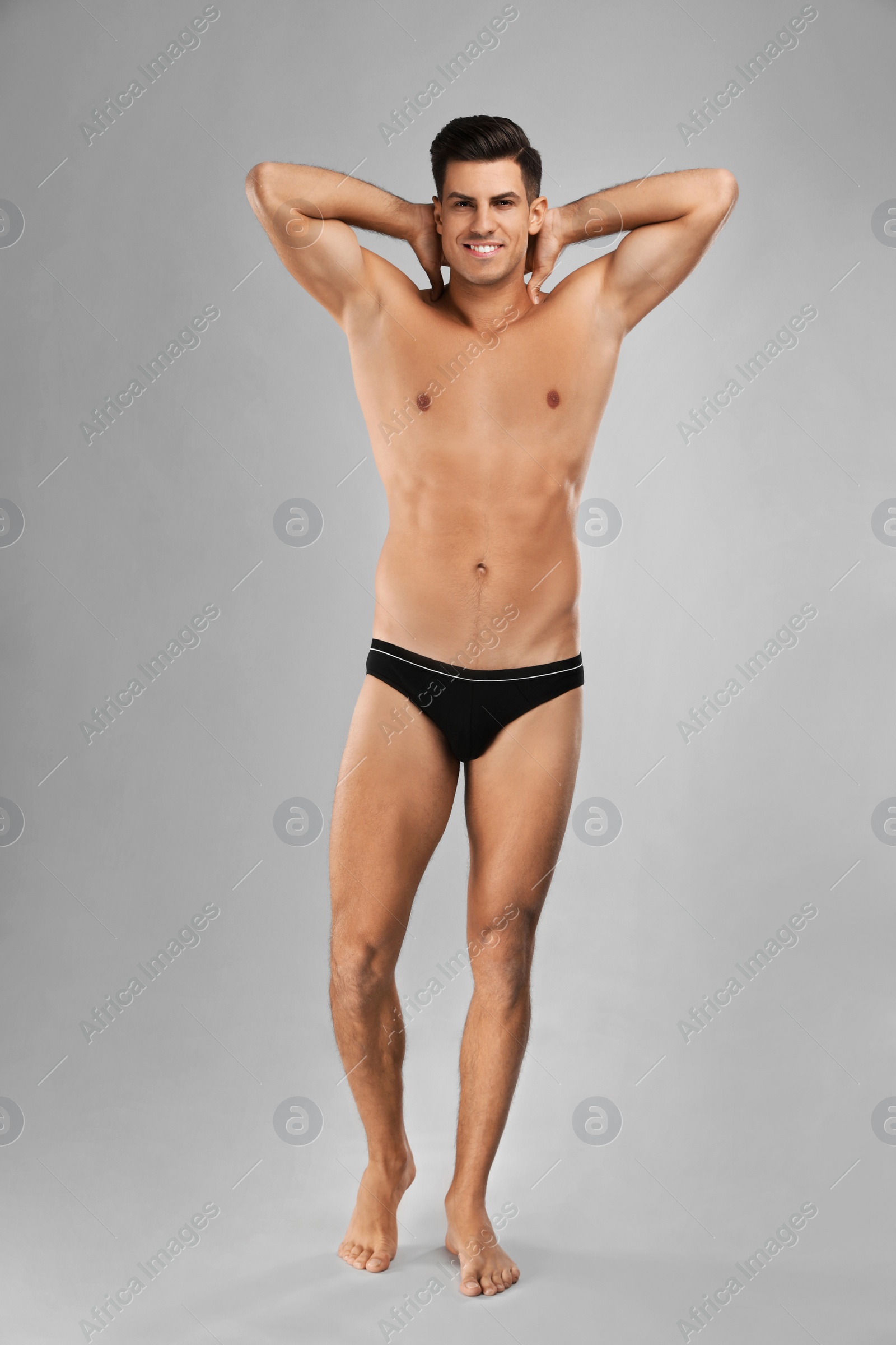 Photo of Handsome man in black underwear on light grey background