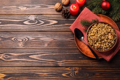 Photo of Traditional Christmas slavic dish kutia served on wooden table, flat lay. Space for text