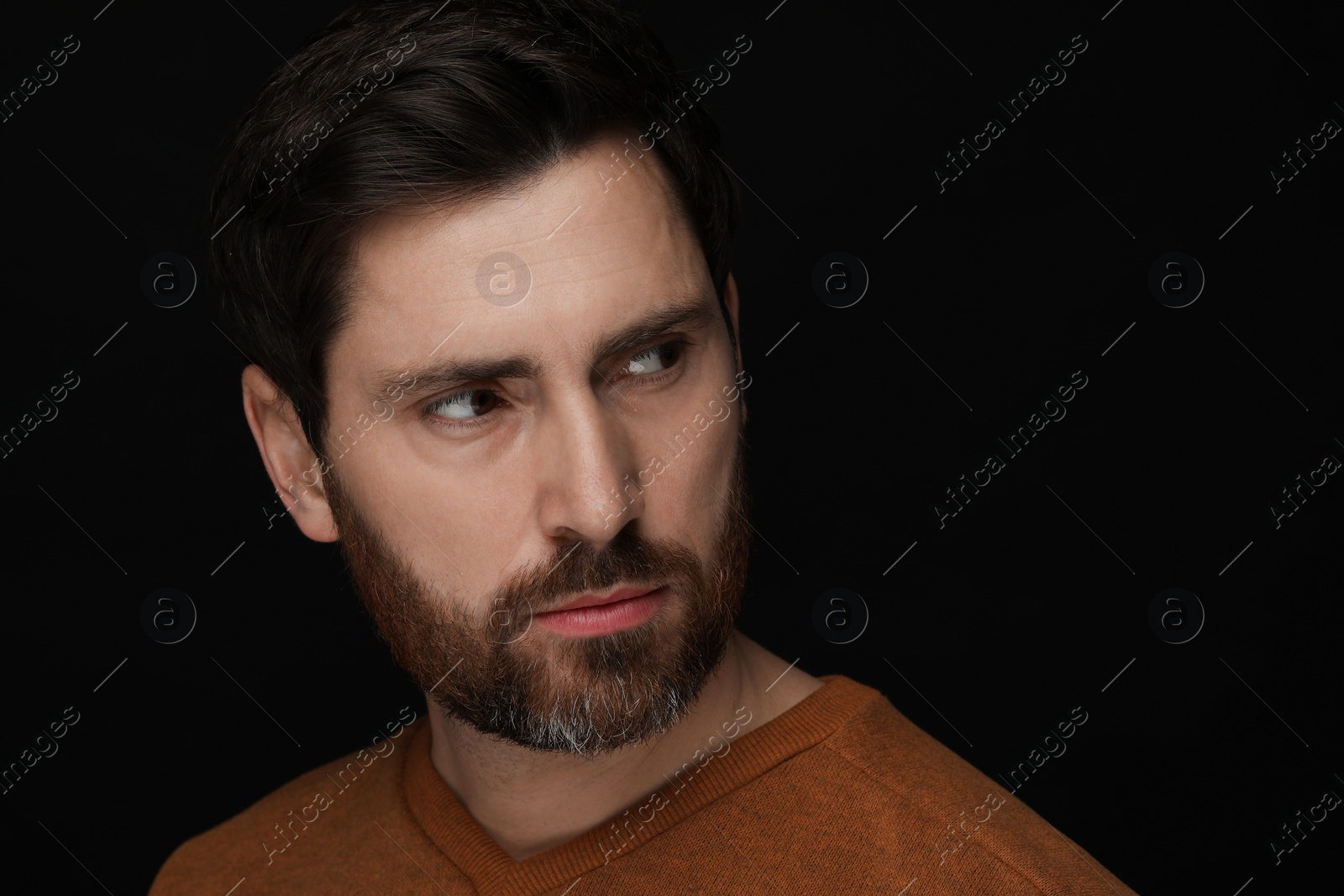 Photo of Evil eye. Man with scary eyes on black background, closeup and space for text