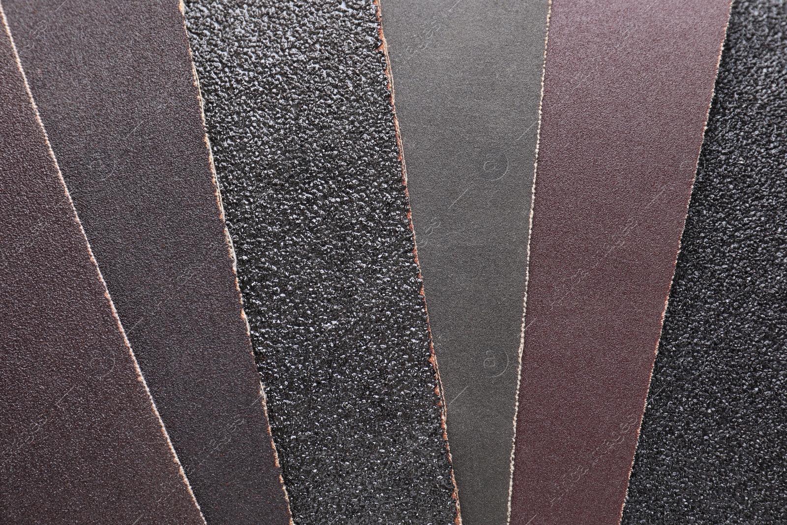 Photo of Many sheets of sandpaper as background, top view
