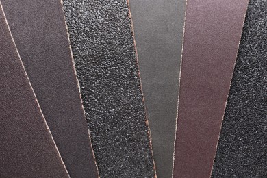 Many sheets of sandpaper as background, top view