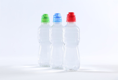 Plastic bottles with pure water on white background