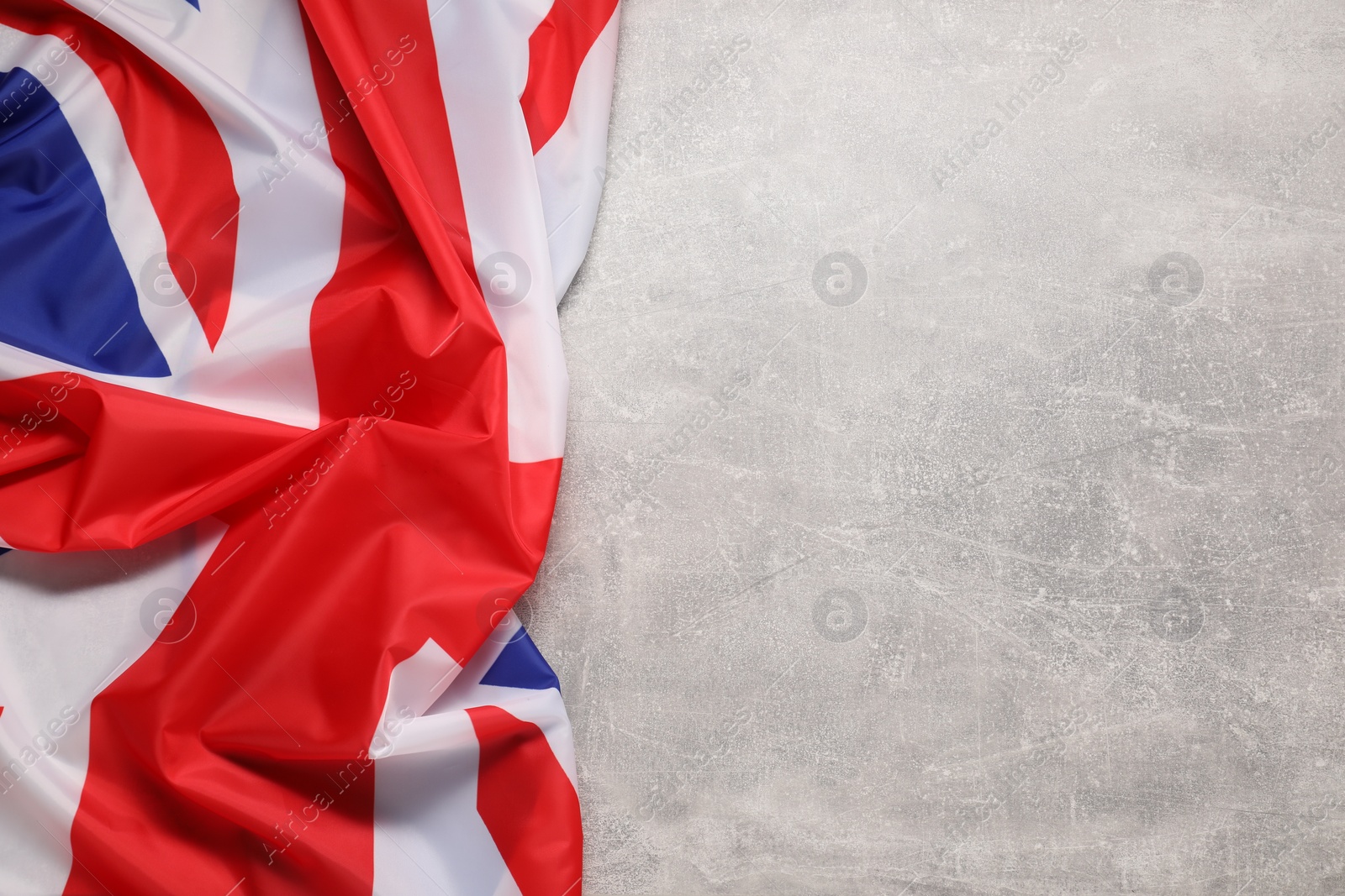 Photo of Flag of United Kingdom on light gray background, top view. Space for text