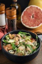 Photo of Delicious pomelo salad with shrimps served on wooden table