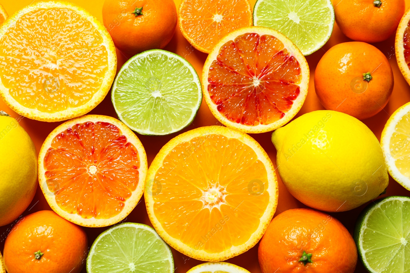 Photo of Different citrus fruits on color background, top view