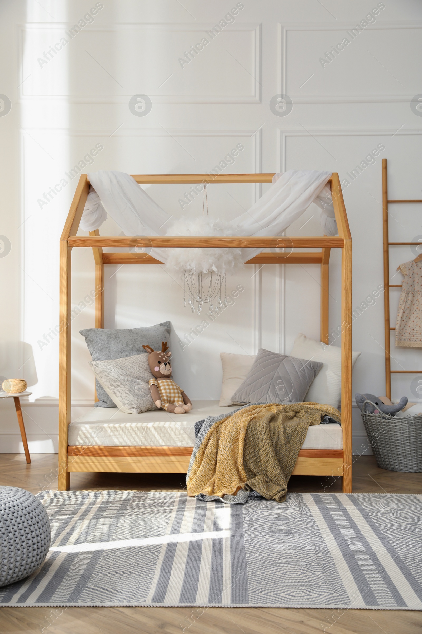 Photo of Stylish child room interior with house bed