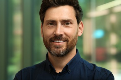 Photo of Portrait of handsome stylish man in office