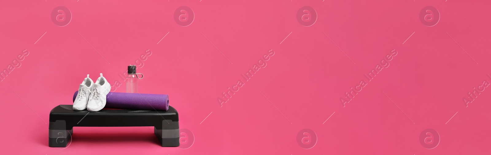 Image of Step platform, mat, shoes and bottle of water on pink background, space for text. Banner design