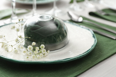 Photo of Stylish tableware with flowers on table, closeup. Festive setting
