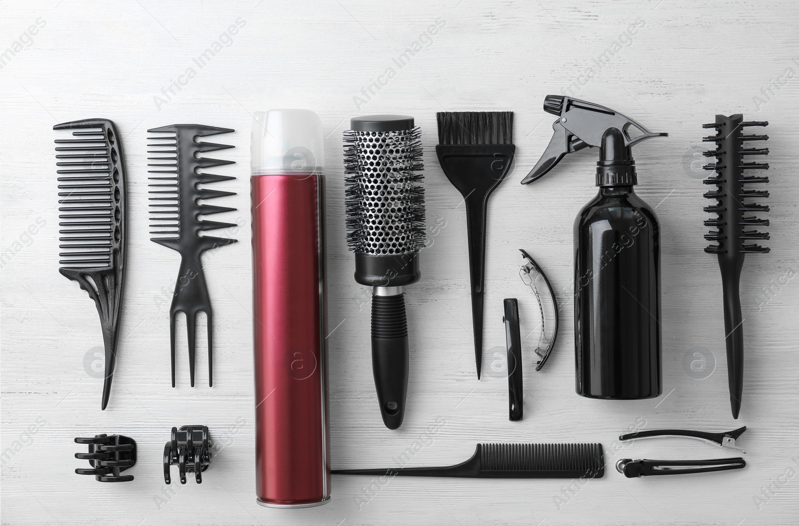 Photo of Flat lay composition with professional hairdresser tools on wooden background