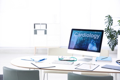 Photo of Computer monitor with word CARDIOLOGY on table in doctor's office