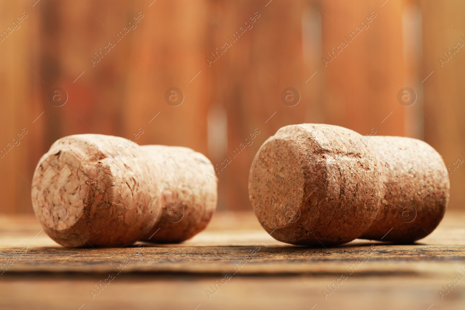 Photo of Corks of wine bottles on wooden table, closeup