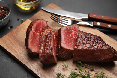 Photo of Delicious sliced beef tenderloin served on table, closeup