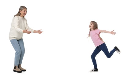 Happy girl running towards her grandmother on white background