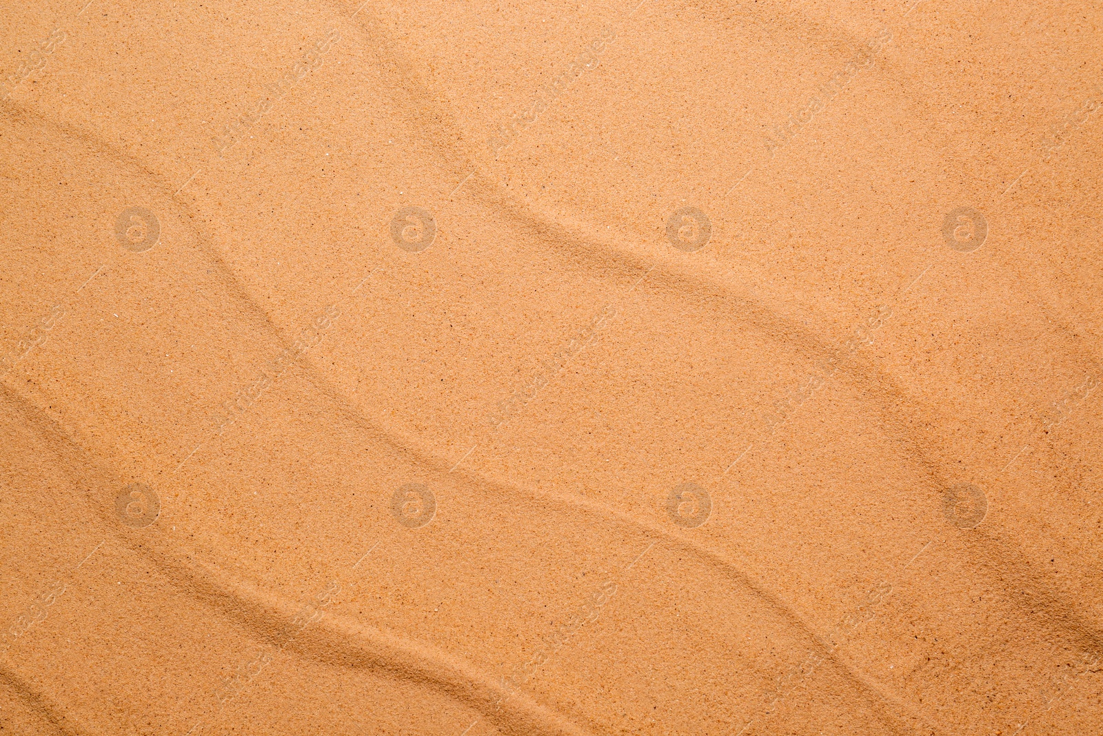 Photo of Beige clean beach sand as background, top view. Summer vacation