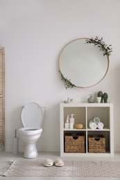 Photo of Interior of modern bathroom with round mirror