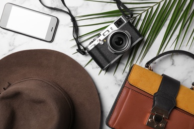 Flat lay composition with camera and travel blogger's stuff on marble background