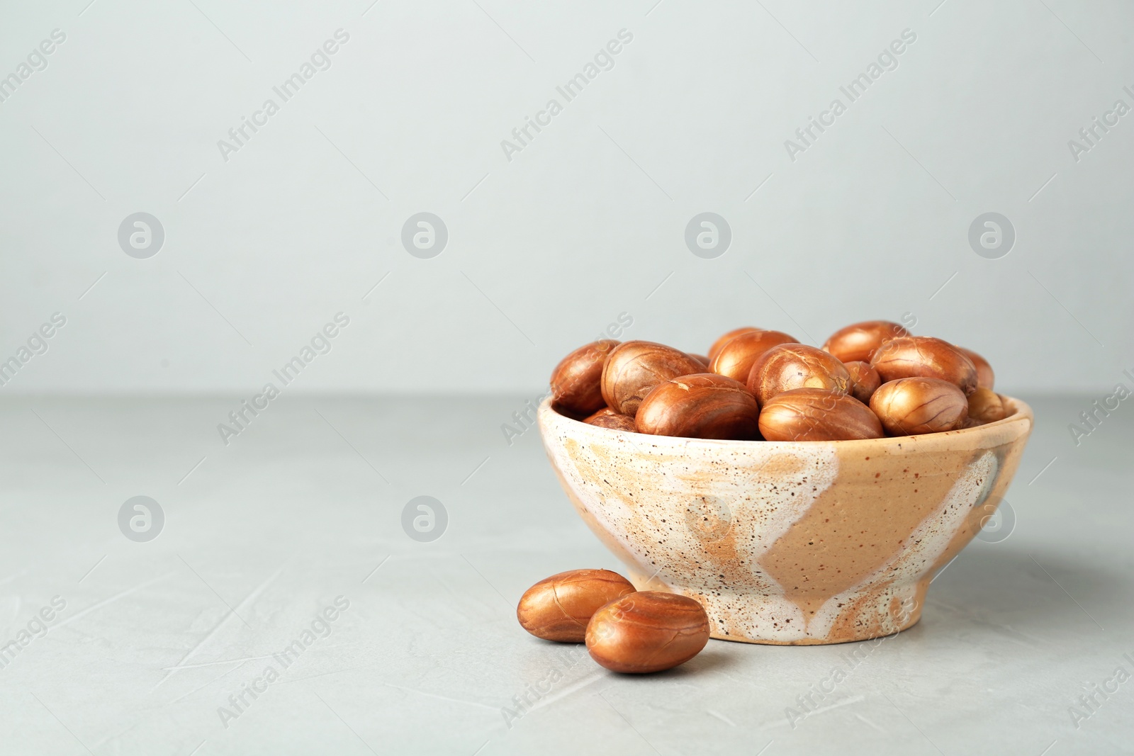 Photo of Bowl of jackfruit seeds on light table. Space for text