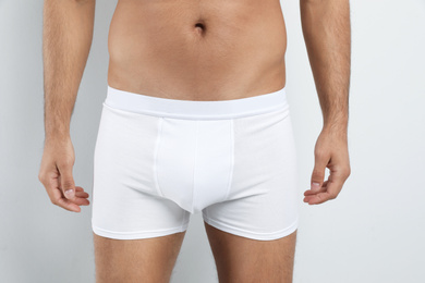 Man in underwear on white background, closeup