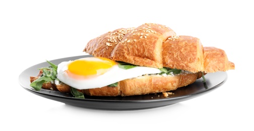 Delicious croissant with arugula and fried egg isolated on white