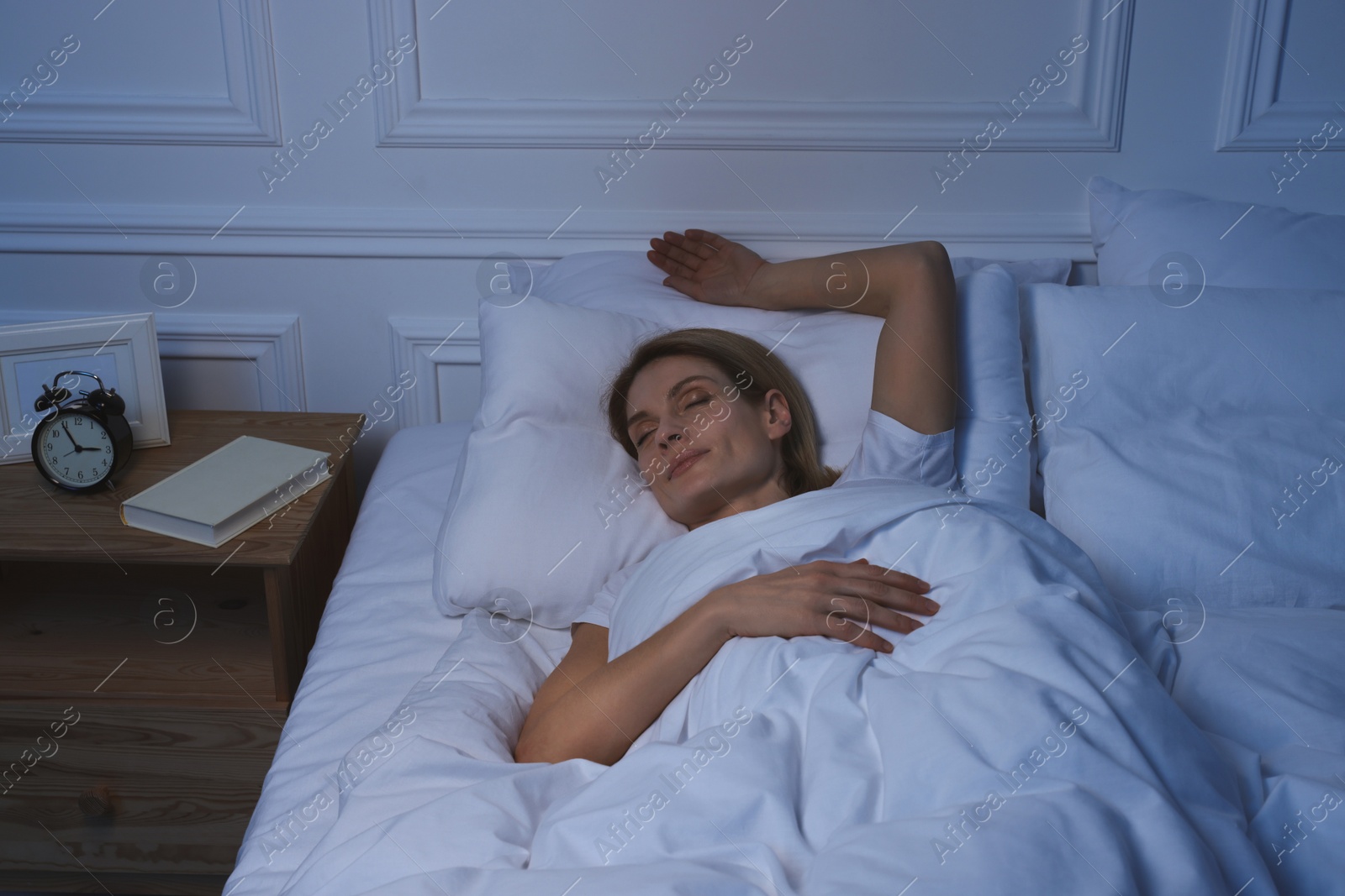 Photo of Beautiful woman sleeping in bed at night