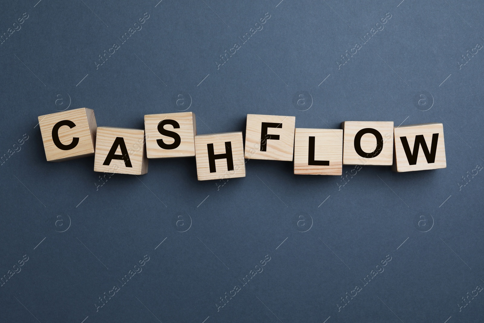 Image of Wooden cubes with phrase Cash FLow on grey background, flat lay