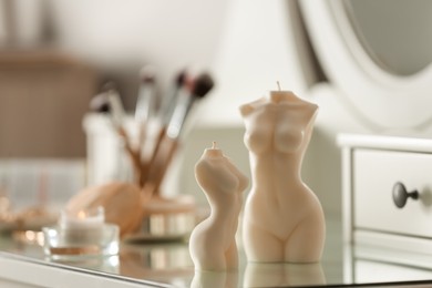 Beautiful body shaped candles on dressing table indoors, space for text