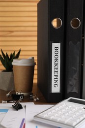 Photo of Bookkeeper's workplace with folders and documents on table